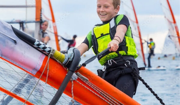 Jongen op een boot tijdens een kindervakantieorganisatie. Ontdek de voordelen van aangesloten te zijn bij Jantje Beton als speeltuin of kindervakantieorganisatie.